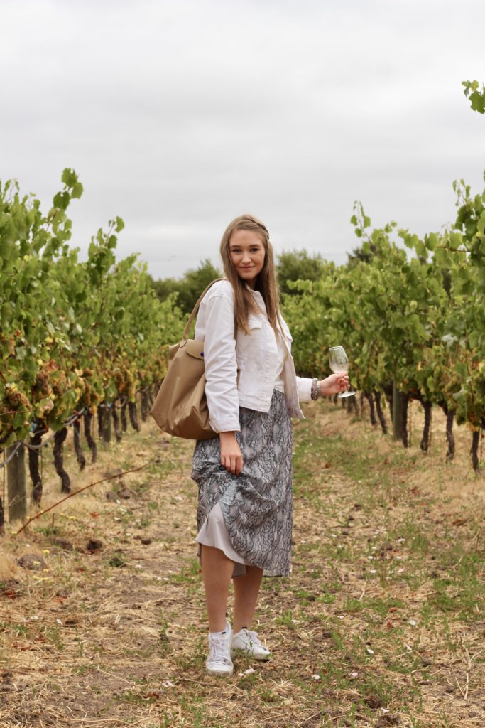 Outfit of the day in Sonoma and Napa valley in snakeskin midi skirt and white denim jacket with white Adidas Sleek Sneakers