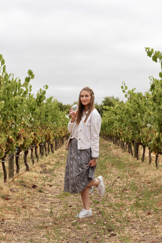 Outfit of the day in Sonoma and Napa valley in snakeskin midi skirt and white denim jacket with white Adidas Sleek Sneakers