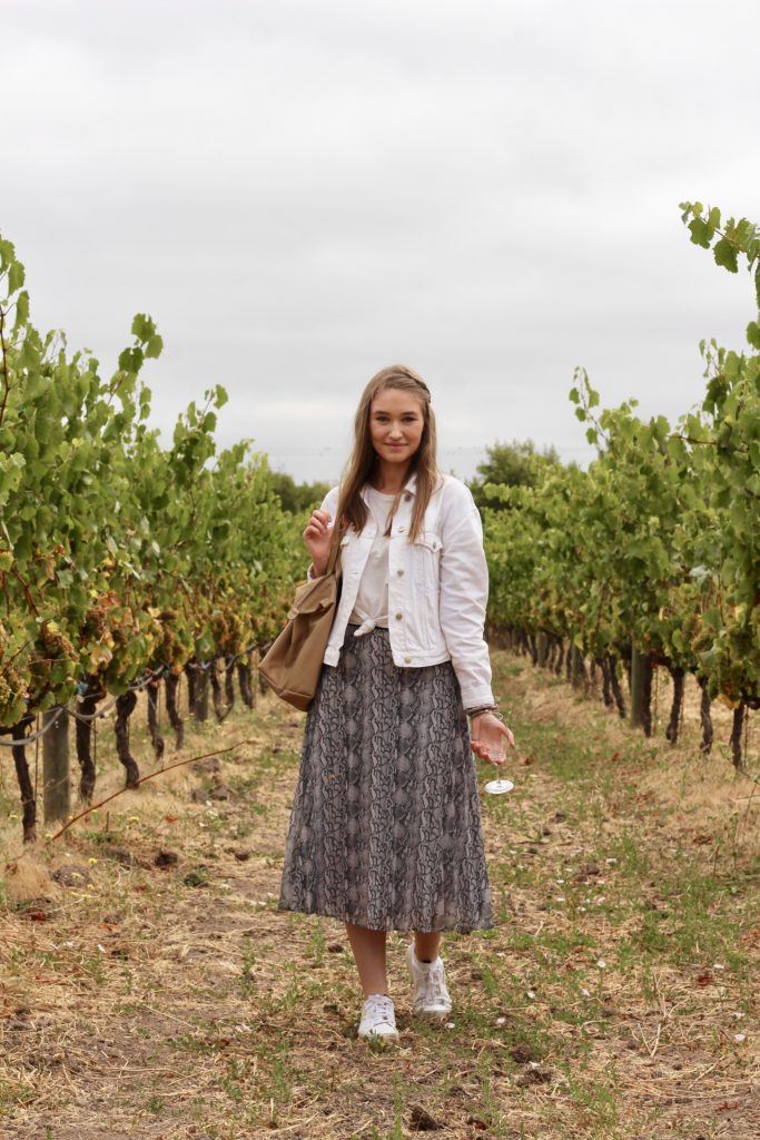 Outfit of the day in Sonoma and Napa valley in snakeskin midi skirt and white denim jacket with white Adidas Sleek Sneakers