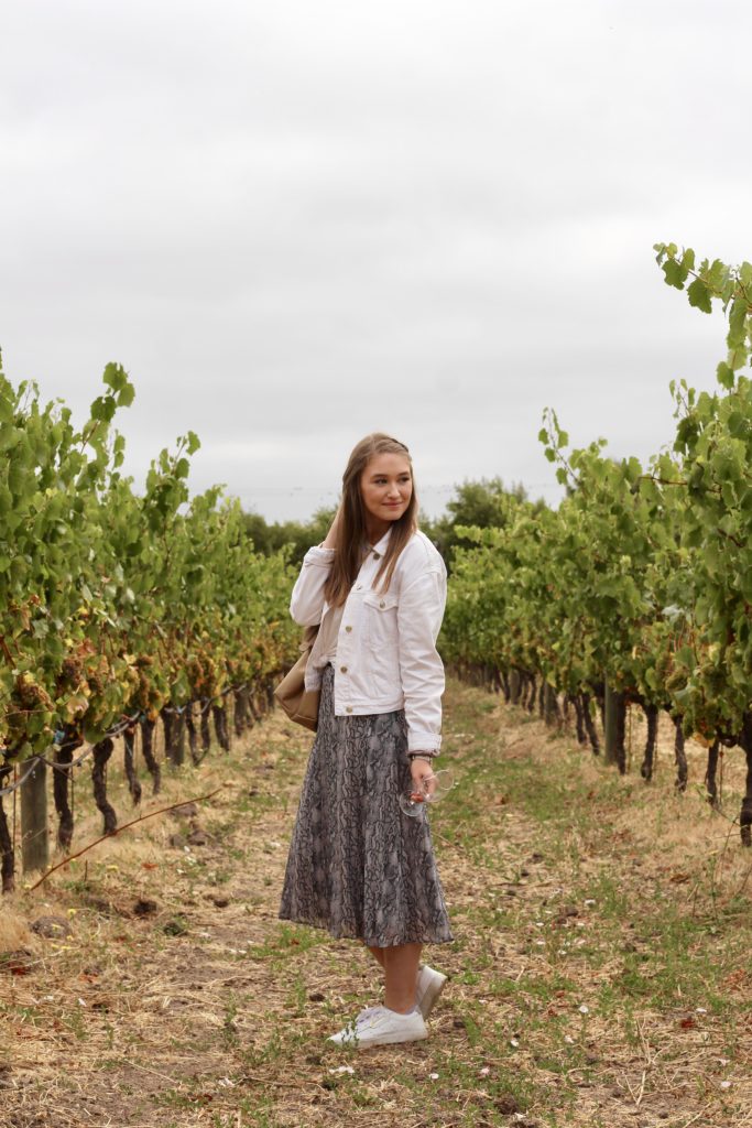 Outfit of the day in Sonoma and Napa valley in snakeskin midi skirt and white denim jacket with white Adidas Sleek Sneakers