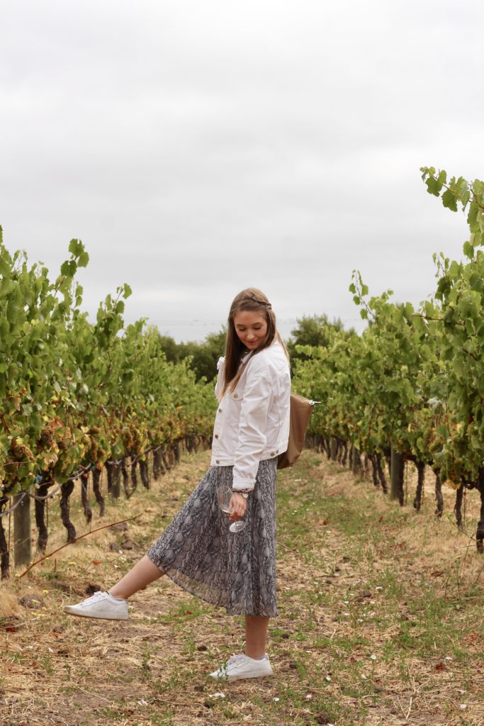 Outfit of the day in Sonoma and Napa valley in snakeskin midi skirt and white denim jacket with white Adidas Sleek Sneakers