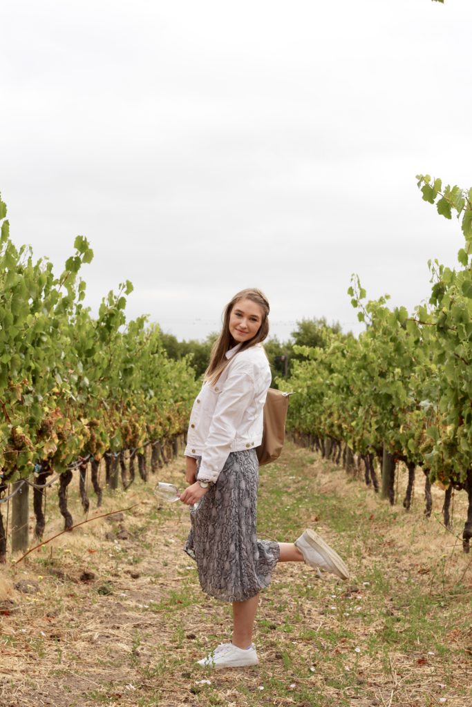 Outfit of the day in Sonoma and Napa valley in snakeskin midi skirt and white denim jacket with white Adidas Sleek Sneakers