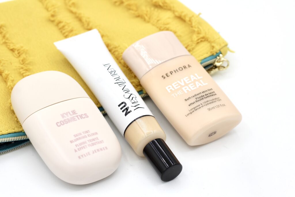 YSL Nu Bare Look Skin Tint vs Kylie Skin Tint Blurring Elixir comparison flat lay